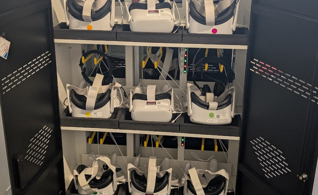 Cabinet of VR headsets with some headphones